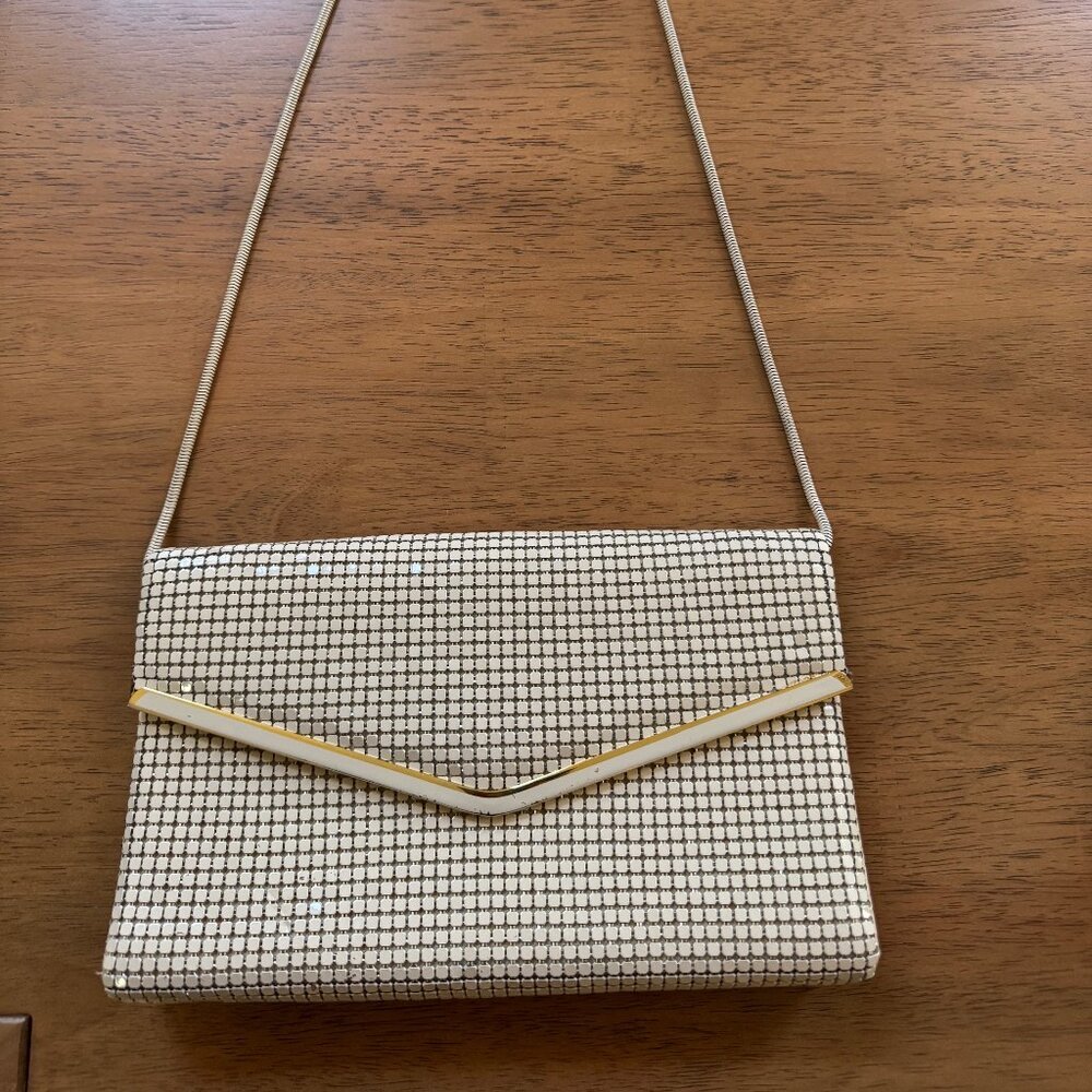 Vintage cream and gold metal mesh convertible clutch purse with a strap.